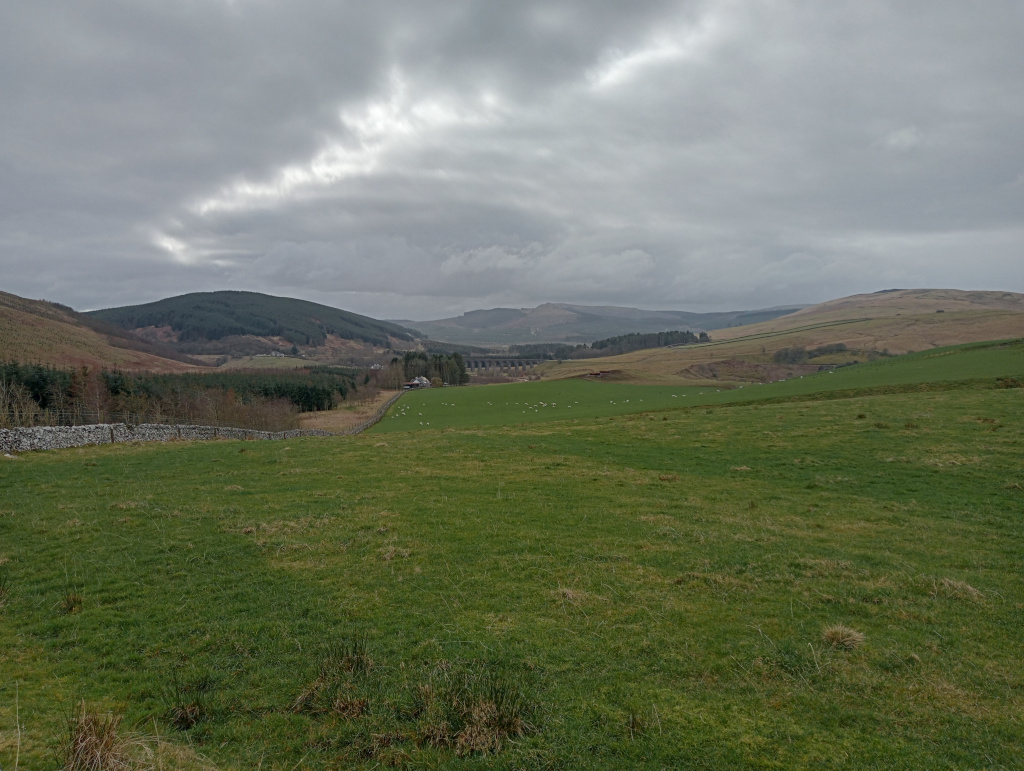 Scenic view of the Scottish Borders, with viaduct in the distance.