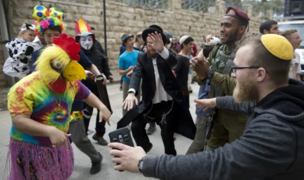 Israelis of all stripes celebrating Purim in the streets of Hebron, West Bank, in 2017