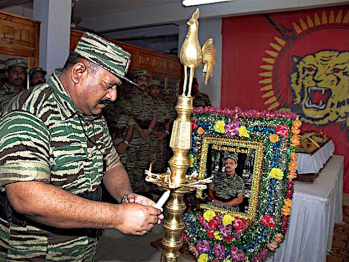 Prabhakaran lights a Christian candle upon a Hindu flame