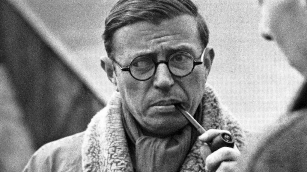 Bespectacled Jean-Paul Sartre smoking a pipe.
